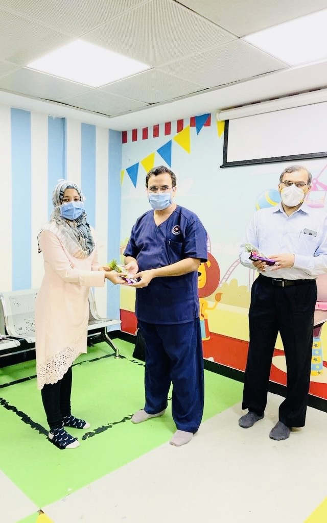 Bilqees receiving token of appreciation from Dr Girish Chinnaswamy